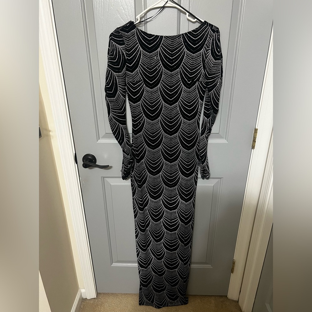 Black and silver long sleeve/long dress. Brand new with tags. XS